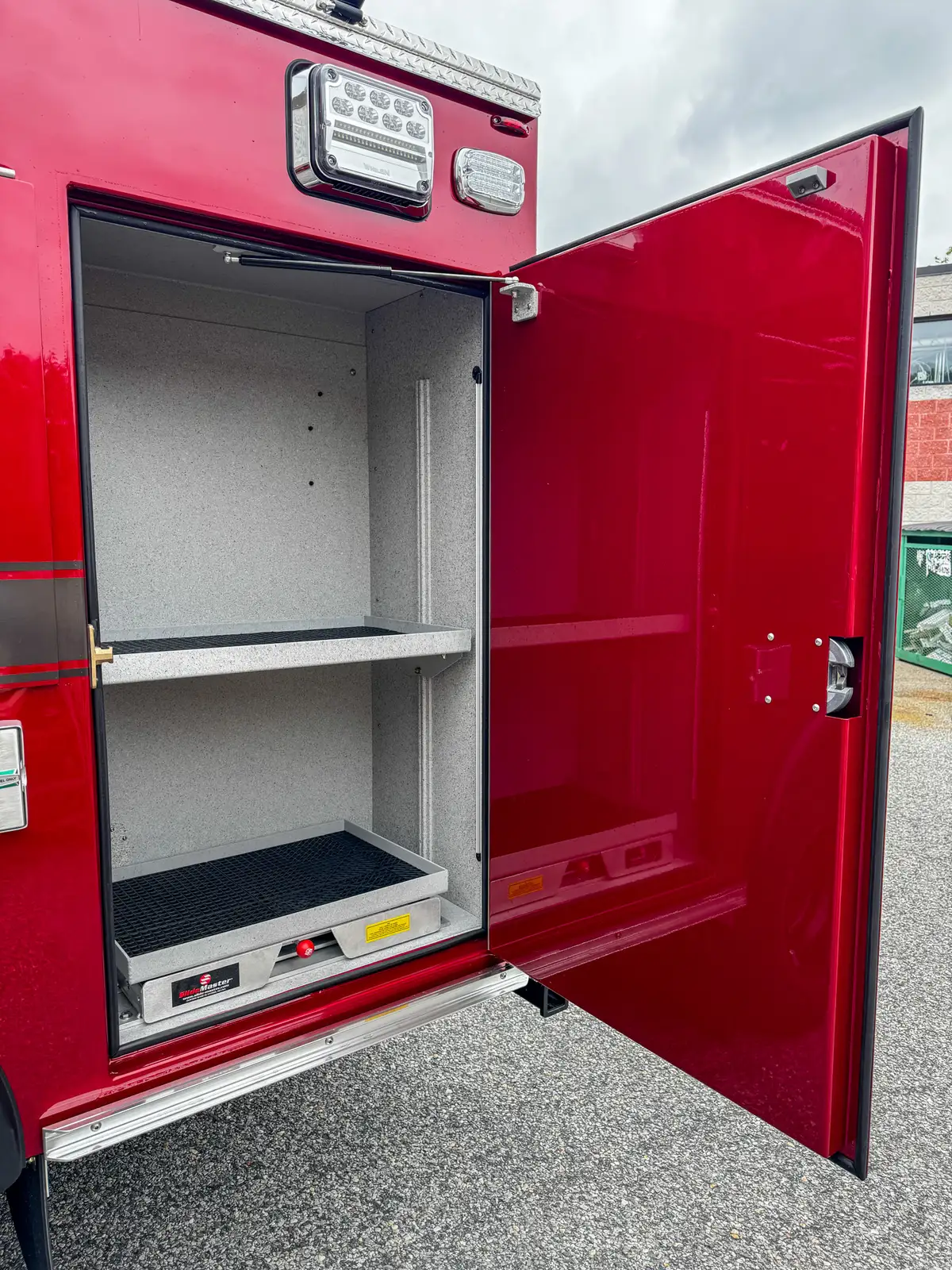 Side compartment interior showing shelf and empty lower storage space.